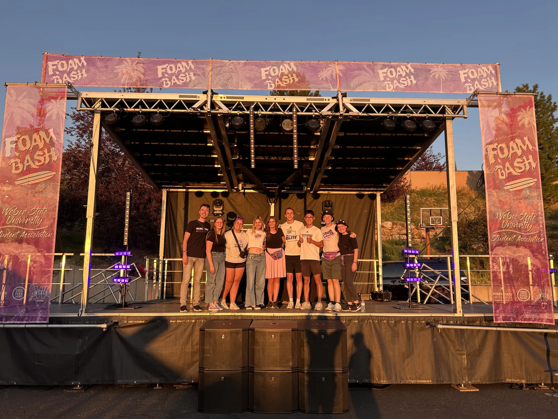 School and college students on stage under truss lighting at a Utah campus event