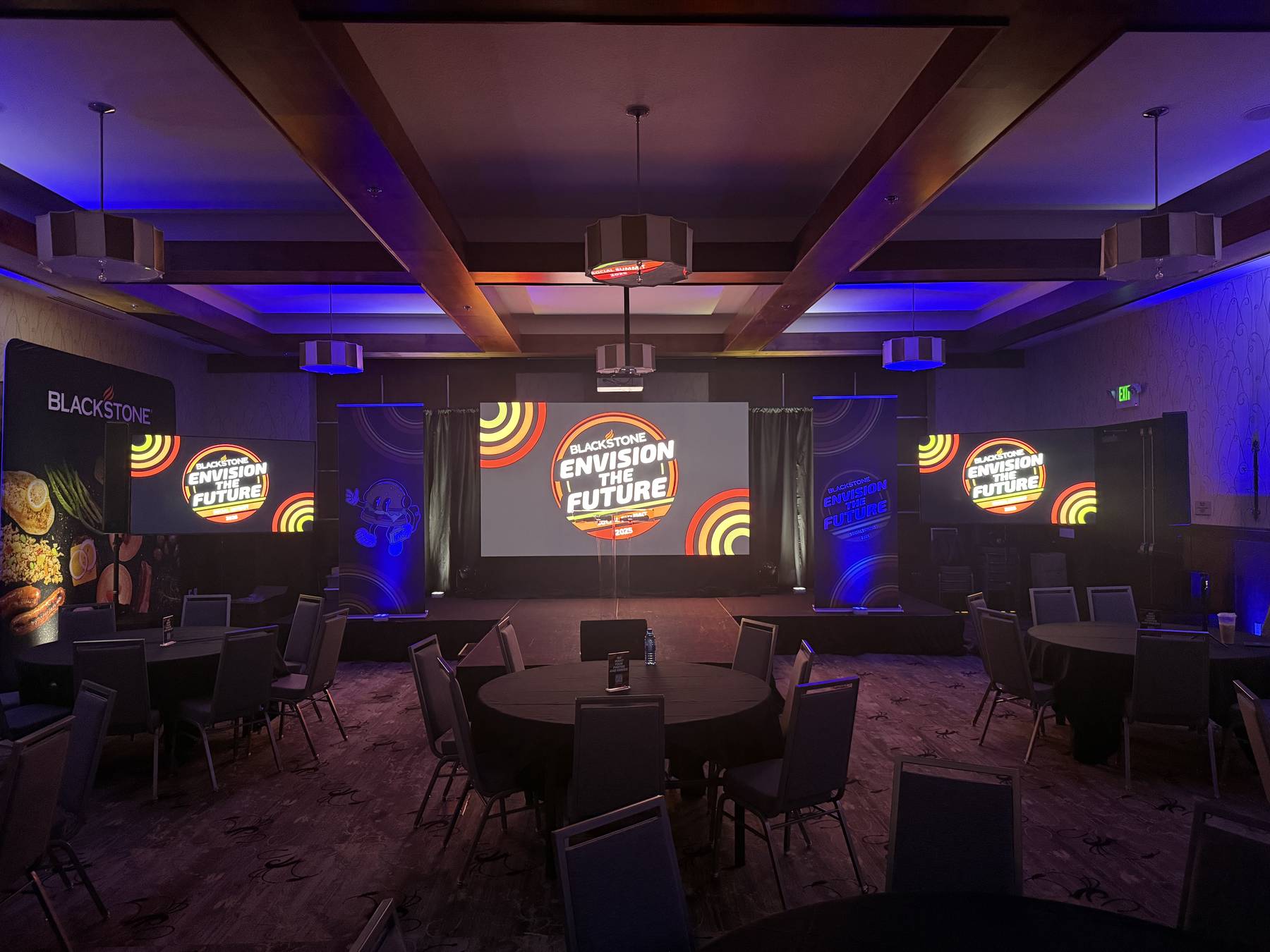 Hotel ballroom conference set with round tables and blue accent lighting