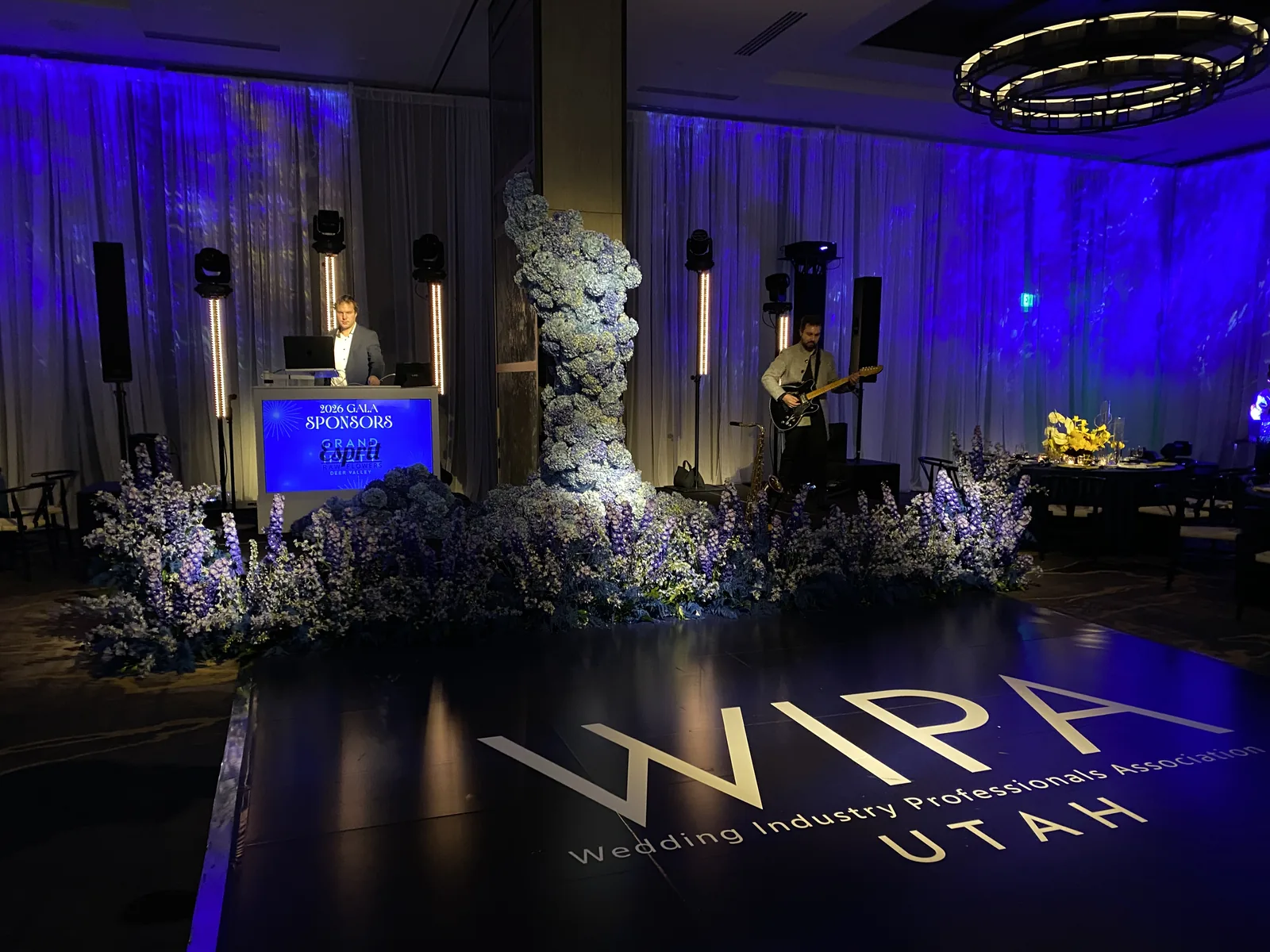 Gala event lighting with moving heads, LED tubes, and a printed dance floor