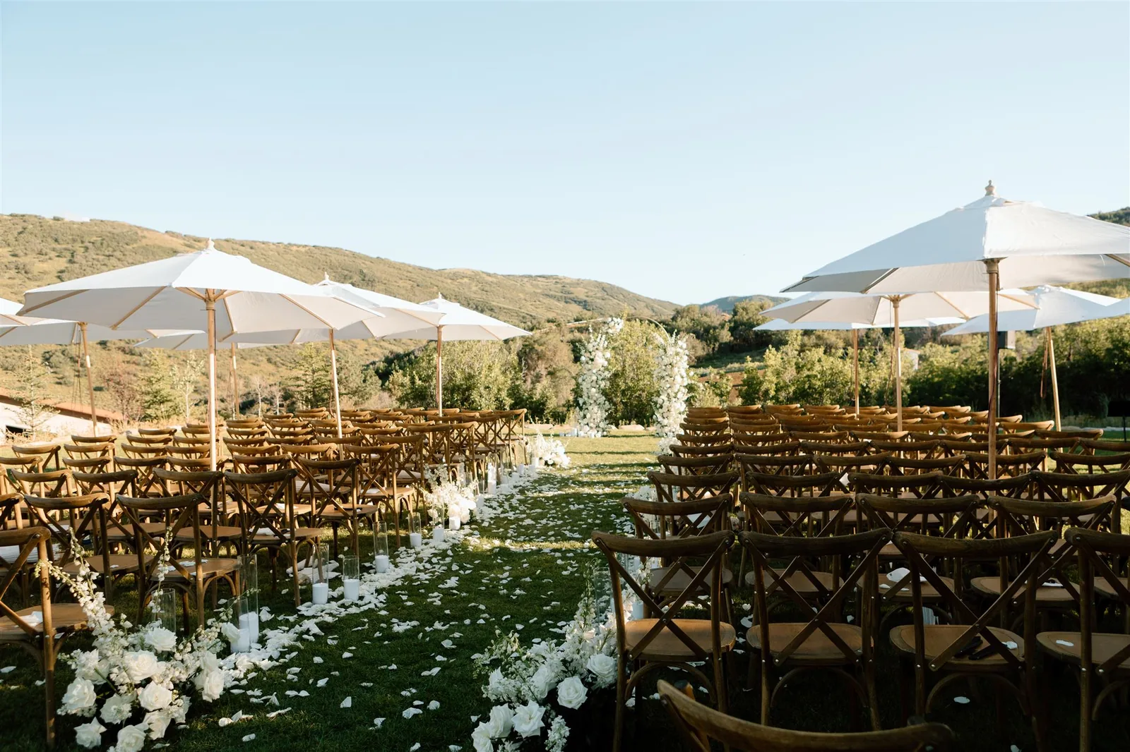 Outdoor lawn event sound and seating with shade umbrellas and mountain views